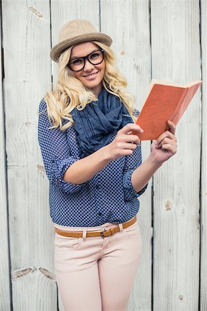 simsearch:400-04722731,k - Smiling fashionable blonde holding book outdoors on wooden background Stock Photo - Budget Royalty-Free & Subscription, Code: 400-07126949