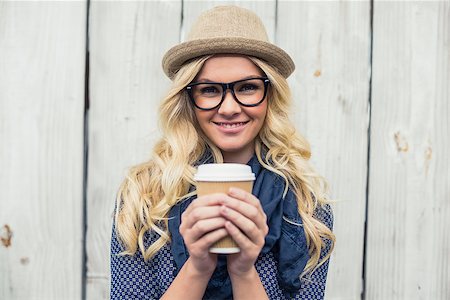 simsearch:400-04722731,k - Cheerful fashionable blonde holding coffee outdoors on wooden background Stock Photo - Budget Royalty-Free & Subscription, Code: 400-07126951
