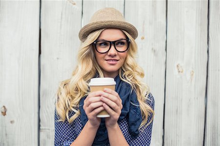 simsearch:400-04135676,k - Pensive fashionable blonde holding coffee outdoors on wooden background Stock Photo - Budget Royalty-Free & Subscription, Code: 400-07126952
