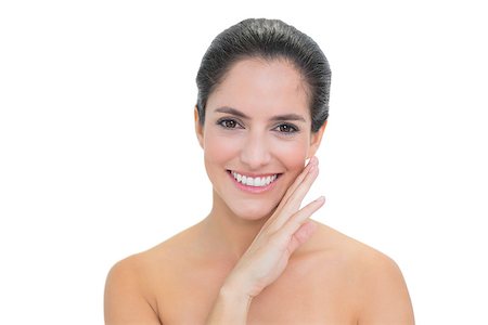 Smiling bare brunette touching her right cheek on white background Foto de stock - Super Valor sin royalties y Suscripción, Código: 400-07128893