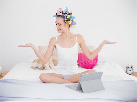 simsearch:400-07129766,k - Calm natural brown haired woman in hair curlers moving her arms in bright bedroom Stock Photo - Budget Royalty-Free & Subscription, Code: 400-07129729