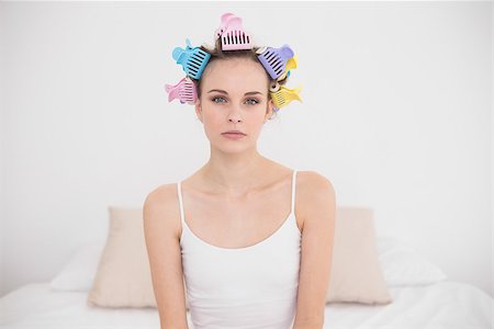 simsearch:400-07129766,k - Upset natural brown haired woman in hair curlers looking at camera in bright bedroom Stock Photo - Budget Royalty-Free & Subscription, Code: 400-07129768