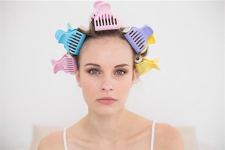 simsearch:400-07129766,k - Stern natural brown haired woman in hair curlers looking at camera in bright bedroom Stock Photo - Budget Royalty-Free & Subscription, Code: 400-07129769