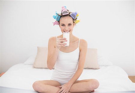 simsearch:400-07129766,k - Attractive natural brown haired woman in hair curlers drinking milk in bright bedroom Stock Photo - Budget Royalty-Free & Subscription, Code: 400-07129777