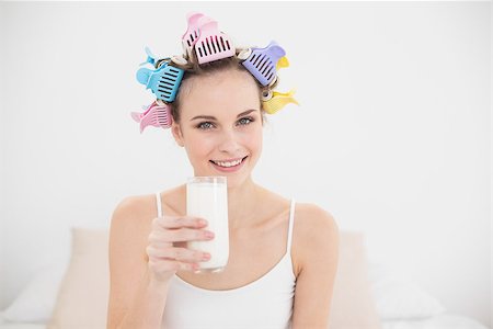simsearch:400-07129766,k - Beautiful natural brown haired woman in hair curlers holding a glass of milk in bright bedroom Stock Photo - Budget Royalty-Free & Subscription, Code: 400-07129778