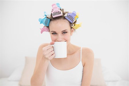 simsearch:400-07129766,k - Delighted natural brown haired woman in hair curlers enjoying coffee smell in bright bedroom Stock Photo - Budget Royalty-Free & Subscription, Code: 400-07129780