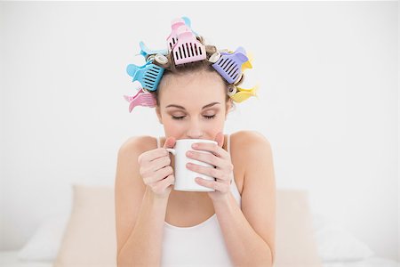 simsearch:400-07129766,k - Peaceful natural brown haired woman in hair curlers enjoying coffee smell in bright bedroom Stock Photo - Budget Royalty-Free & Subscription, Code: 400-07129781
