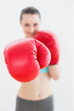 Portrait of a blurred smiling woman in red boxing gloves at fitness studio Stock Photo - Budget Royalty-Free & Subscription, Code: 400-07136580