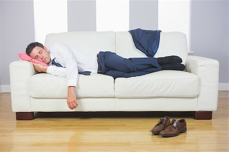 Calm handsome businessman sleeping on couch after work at home Stock Photo - Budget Royalty-Free & Subscription, Code: 400-07139173