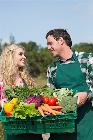 smiling couple in vegetable garden - Happy couple presenting vegetables while looking at each other in their garden Stock Photo - Budget Royalty-Free & Subscription, Code: 400-07139484