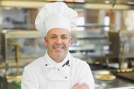 Mature head chef posing with crossed arms standing in a professional kitchen Stock Photo - Budget Royalty-Free & Subscription, Code: 400-07140075