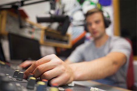 disc jockey radio - Handsome radio host moderating touching switch in studio at college Stock Photo - Budget Royalty-Free & Subscription, Code: 400-07142013