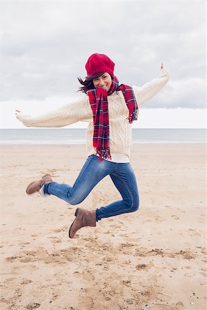 simsearch:400-07181052,k - Full length of a woman in stylish warm clothing jumping at the beach Stock Photo - Budget Royalty-Free & Subscription, Code: 400-07142250