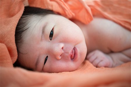 Newborn Asian baby girl on bed, 7 days after birth Stock Photo - Budget Royalty-Free & Subscription, Code: 400-07165615