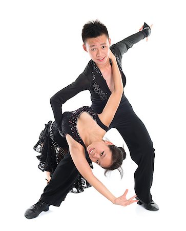 Modern young Asian teens couple latin dancers dancing in front of the studio background, full length isolated white. Stock Photo - Budget Royalty-Free & Subscription, Code: 400-07165635