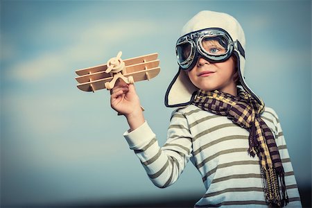 Smiling child with wooden plane Stock Photo - Budget Royalty-Free & Subscription, Code: 400-07166383