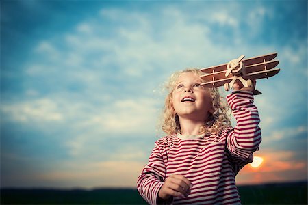 Girl with plane at sunset Stock Photo - Budget Royalty-Free & Subscription, Code: 400-07166393