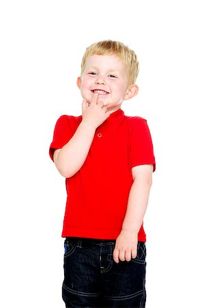 Young boy wearing jeans and a red T-shirt stood isolated on a white background giggling Stock Photo - Budget Royalty-Free & Subscription, Code: 400-07166438