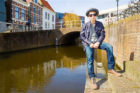 simsearch:400-04332775,k - Cute teenage boy in hat (full-length portrait) against canal background Stock Photo - Budget Royalty-Free & Subscription, Code: 400-07167259