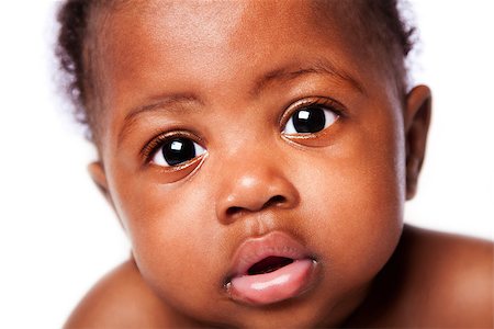 Closeup of cute adorable beautiful face of African baby with innocent expression, on white. Stock Photo - Budget Royalty-Free & Subscription, Code: 400-07167624