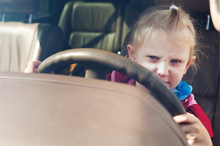 small girl driving a car Stock Photo - Budget Royalty-Free & Subscription, Code: 400-07169740