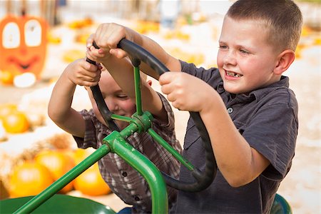 riding crop - Adorable Young Boys Playing on an Old Tractor in a Rustic Outdoor Fall Setting. Stock Photo - Budget Royalty-Free & Subscription, Code: 400-07174824