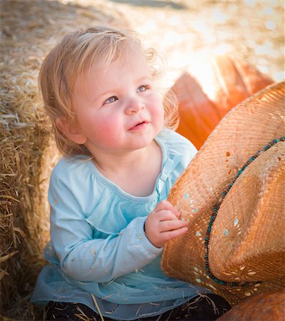 farmers market family - Adorable Baby Girl with Cowboy Hat in a Country Rustic Setting at the Pumpkin Patch. Stock Photo - Budget Royalty-Free & Subscription, Code: 400-07174835