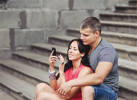 step shot - Young couple of tourists sitting on steps making pictures. Stock Photo - Budget Royalty-Free & Subscription, Code: 400-07175585