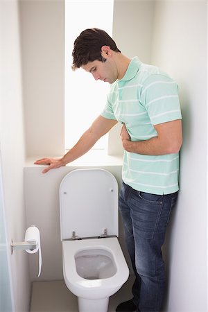 Side view of a young man with stomach sickness about to vomit into the toilet Stock Photo - Budget Royalty-Free & Subscription, Code: 400-07177917