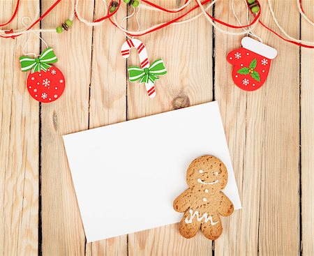 Christmas decor, gingerbread cookie and card for copy space on wooden table Stock Photo - Budget Royalty-Free & Subscription, Code: 400-07179634