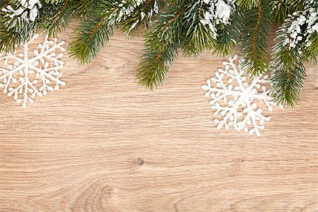 fir needle - Christmas fir tree covered with snow on wooden board background Stock Photo - Budget Royalty-Free & Subscription, Code: 400-07179630