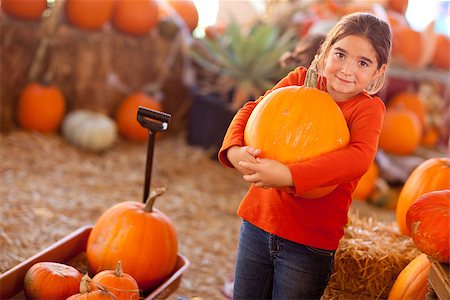 Cute Girl Choosing A Pumpkin at A Pumpkin Patch One Fall Day. Stock Photo - Budget Royalty-Free & Subscription, Code: 400-07170162