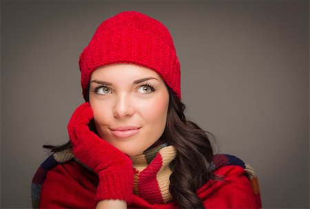 simsearch:649-06532763,k - Happy Mixed Race Woman Wearing Winter Hat and Gloves Looking to the Side on Gray Background. Photographie de stock - Aubaine LD & Abonnement, Code: 400-07170554