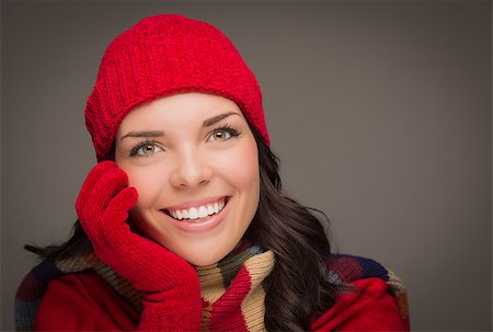 simsearch:649-06532763,k - Happy Mixed Race Woman Wearing Winter Hat and Gloves on Gray Background. Photographie de stock - Aubaine LD & Abonnement, Code: 400-07170555