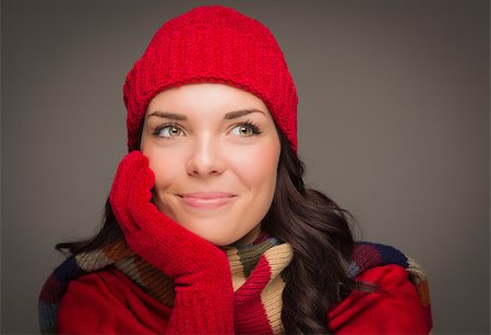 simsearch:649-06532763,k - Happy Mixed Race Woman Wearing Winter Hat and Gloves Looking to the Side on Gray Background. Photographie de stock - Aubaine LD & Abonnement, Code: 400-07170556