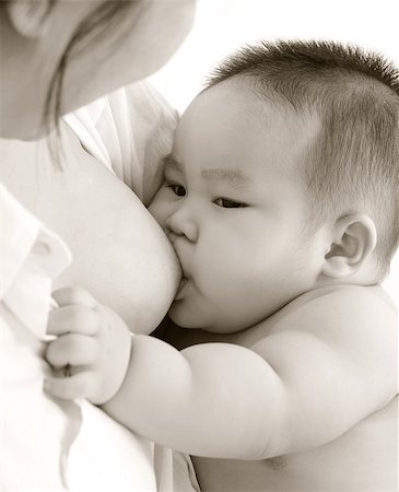 Mother and baby. Close up Asian mother breastfeeding baby boy in sepia tone. Stock Photo - Budget Royalty-Free & Subscription, Code: 400-07171484