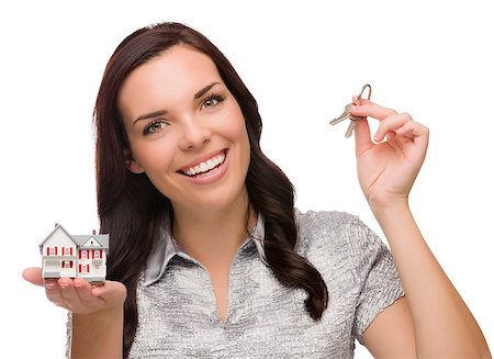 Mixed Race Female Presenting House Keys Holding a Small House Isolated on White Background. Foto de stock - Super Valor sin royalties y Suscripción, Código: 400-07172157