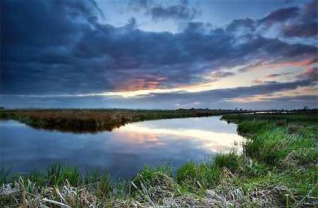 simsearch:400-06408905,k - red sunbeams at sunset before storm over river, Drenthe, Netherlands Stock Photo - Budget Royalty-Free & Subscription, Code: 400-07173523