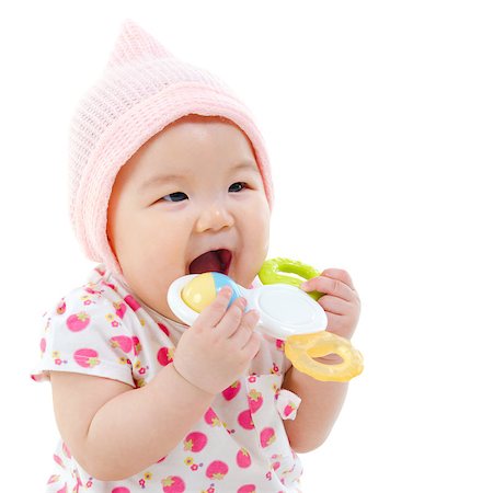 simsearch:400-07171482,k - Beautiful mixed race Asian baby girl teething, biting with her toys, isolated on white background. Stock Photo - Budget Royalty-Free & Subscription, Code: 400-07173564