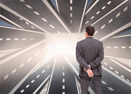 Composite image of businessman standing with hands behind back with streets running together in background Stock Photo - Budget Royalty-Free & Subscription, Code: 400-07180415