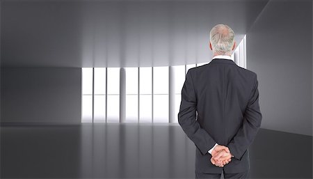 simsearch:400-04283915,k - Composite image of rear view of serious businessman posing in dark room  with windows Stock Photo - Budget Royalty-Free & Subscription, Code: 400-07180503