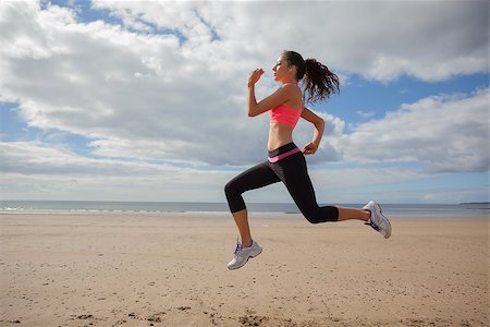 simsearch:400-07181052,k - Full length of a healthy young woman jogging on shore at beach Stock Photo - Budget Royalty-Free & Subscription, Code: 400-07180894