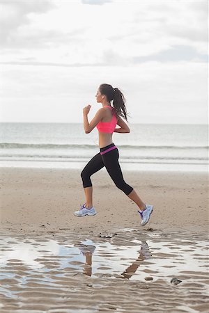 simsearch:400-07181052,k - Full length of a healthy young woman jogging on shore at beach Stock Photo - Budget Royalty-Free & Subscription, Code: 400-07180897