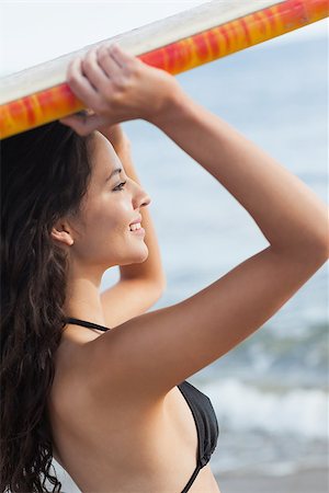 simsearch:400-07181052,k - Smiling young bikini woman holding surfboard over head at beach Stock Photo - Budget Royalty-Free & Subscription, Code: 400-07181046