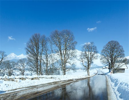 snowy austria village - Spring road with reflection of trees through the alpine village in Austria. Stock Photo - Budget Royalty-Free & Subscription, Code: 400-07208163