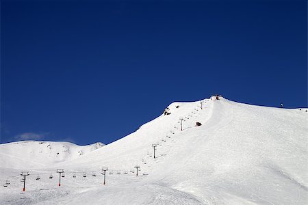 simsearch:400-04636750,k - Ski slope with ropeway at sun winter day. Caucasus Mountains. Georgia, ski resort Gudauri. Stock Photo - Budget Royalty-Free & Subscription, Code: 400-07214194