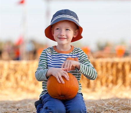 cute positive boy having fun at the pumpkin patch Stock Photo - Budget Royalty-Free & Subscription, Code: 400-07211178