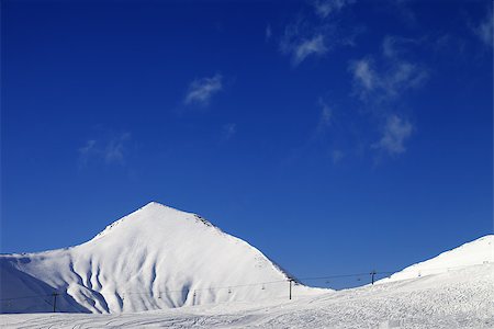 simsearch:400-04636750,k - Ski slope with ropeway at sunny winter day. Caucasus Mountains. Georgia, ski resort Gudauri. Stock Photo - Budget Royalty-Free & Subscription, Code: 400-07211846