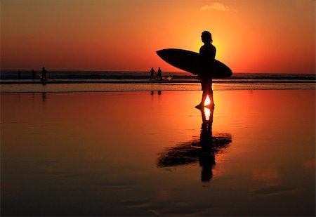 silhouettes surfboards in the sand - Silhouettes of surfer at red sunset. Kuta beach. Bali Stock Photo - Budget Royalty-Free & Subscription, Code: 400-07212726