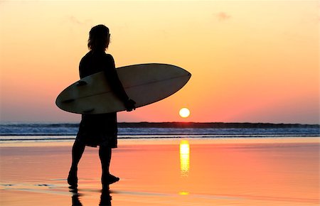 silhouettes surfboards in the sand - Silhouette of surfer at red sunset. Kuta beach. Bali Stock Photo - Budget Royalty-Free & Subscription, Code: 400-07212756